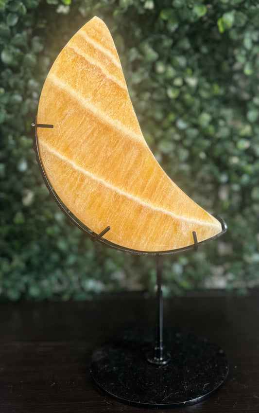 orange calcite moon on stand
