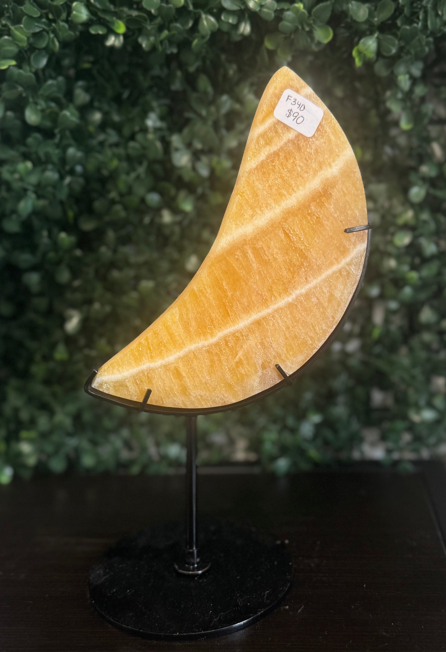 orange calcite moon on stand