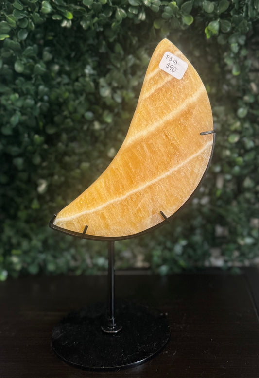 orange calcite moon on stand